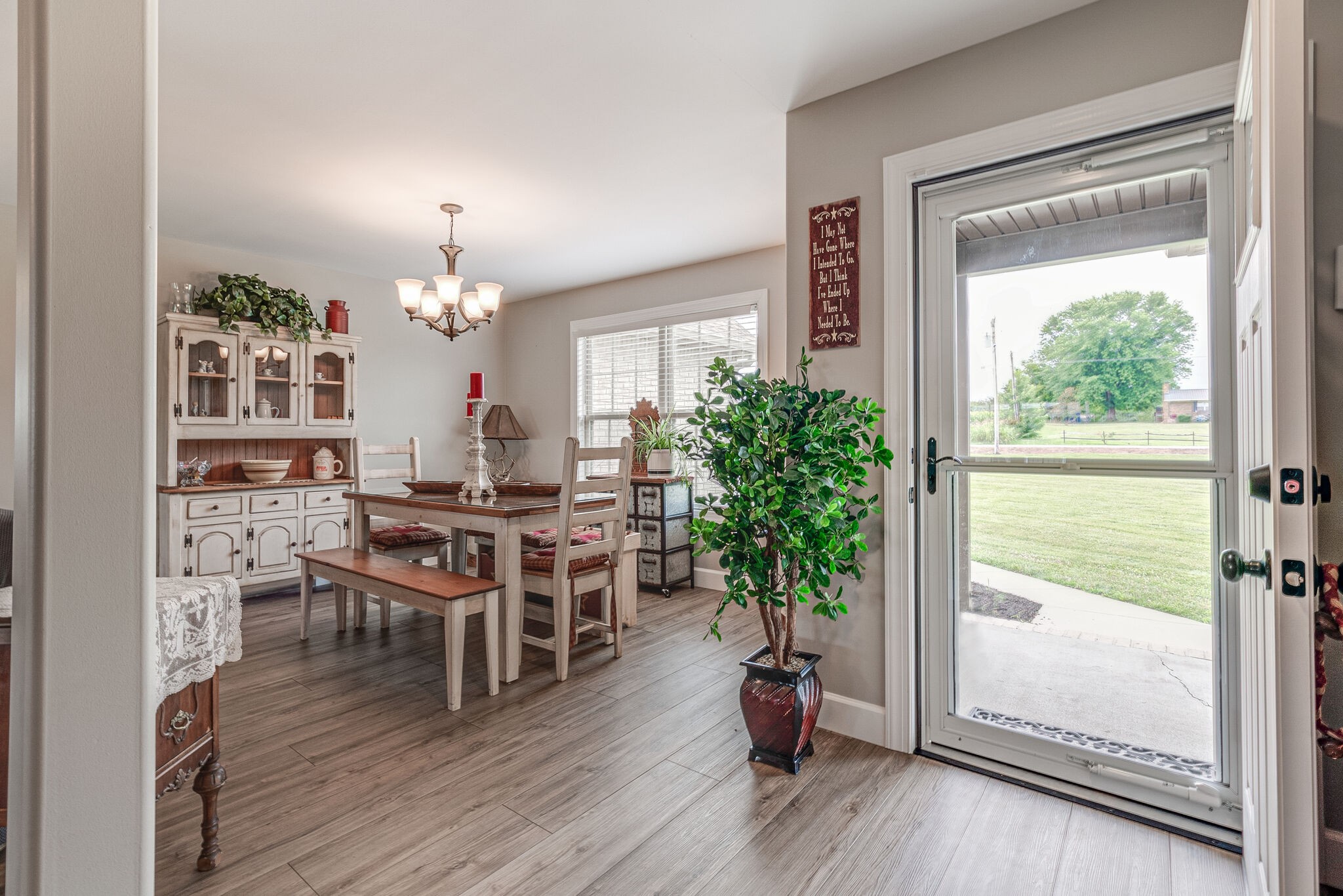 1158 Payne Road Portland, TN 37148 - Photo 8 of 31 a dining room with furniture wooden floor a potted plant and a chandelier