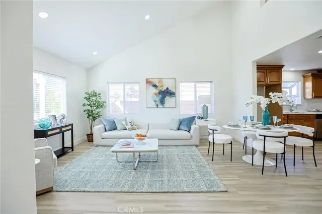 a living room with furniture a rug and a large window