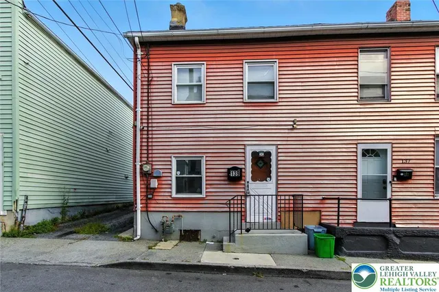 a view of a house with a yard and garage