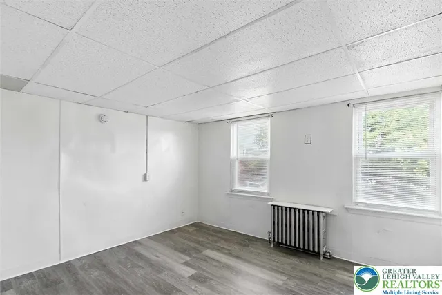 a view of a room with wooden floor