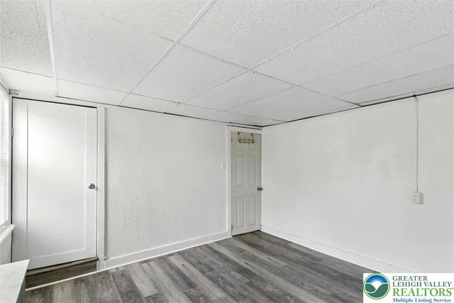 a room with a bed and a large window