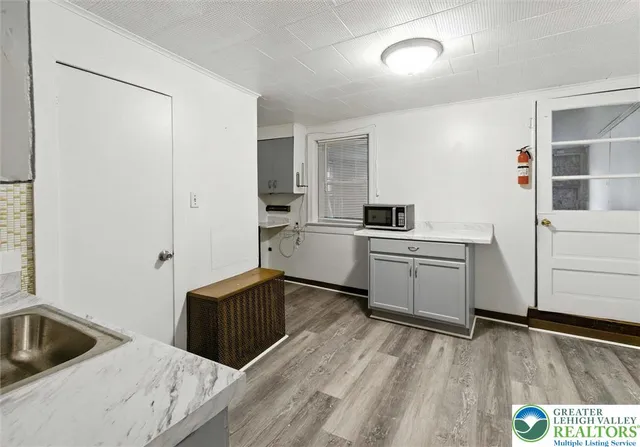a kitchen with a sink and a stove top oven