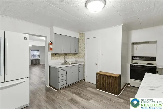 a kitchen with a stove a refrigerator and a sink