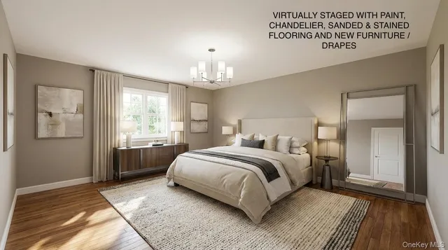 a spacious bedroom with a bed painting on wall and windows