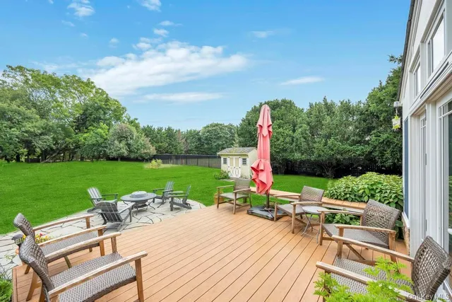 a view of a patio with table and chairs and potted plants