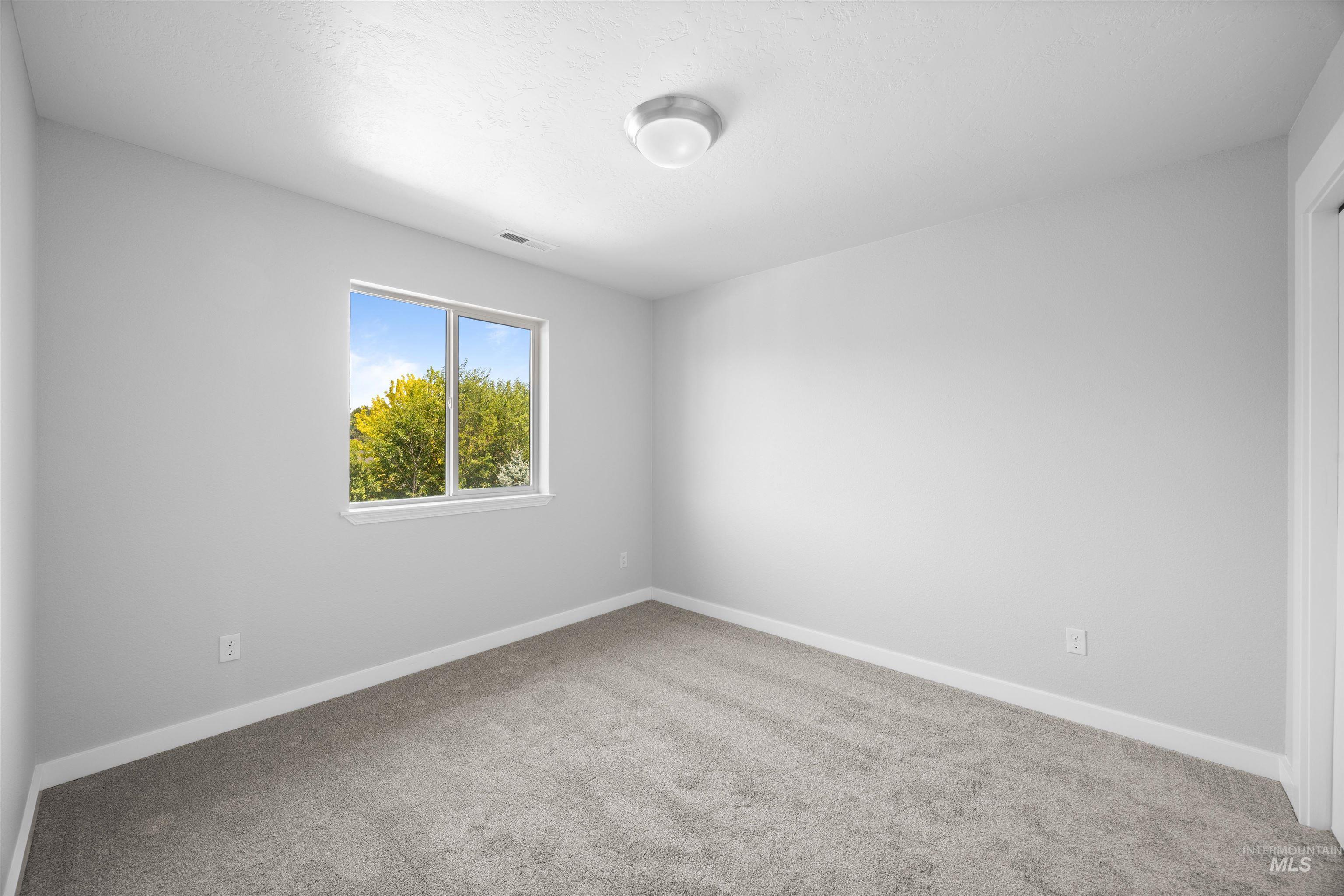 300 South Rocker Avenue Kuna, ID 83634 - Photo 26 of 49 Room featuring light gray carpeting and white trim