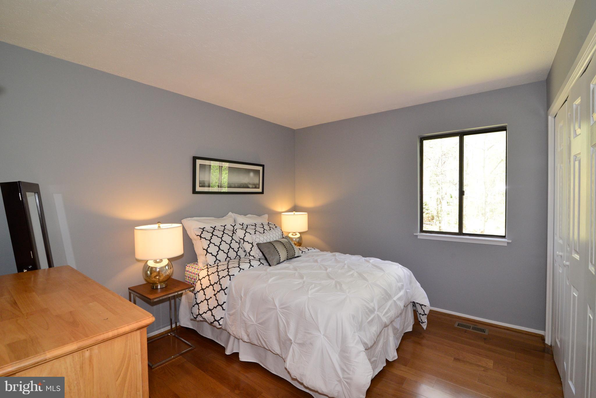 2203 Spinnaker Court Reston, VA 20191 - Photo 19 of 30 a bedroom with a bed and wooden floor