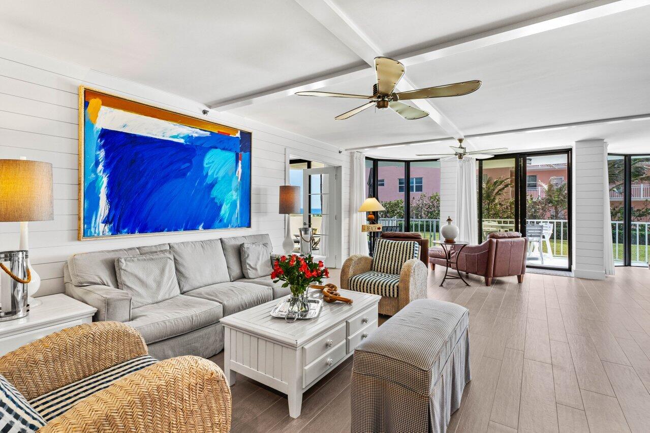 2917 South Ocean Boulevard, Unit 104 Highland Beach, FL 33487 - Photo 11 of 57 a living room with furniture ceiling fan and a rug