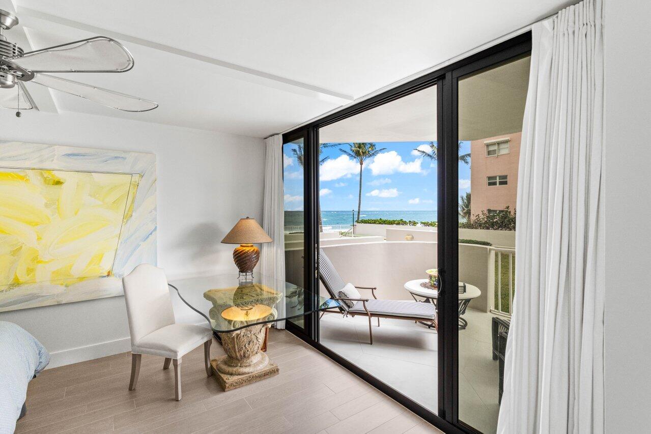 2917 South Ocean Boulevard, Unit 104 Highland Beach, FL 33487 - Photo 21 of 57 a living room with a table and chairs