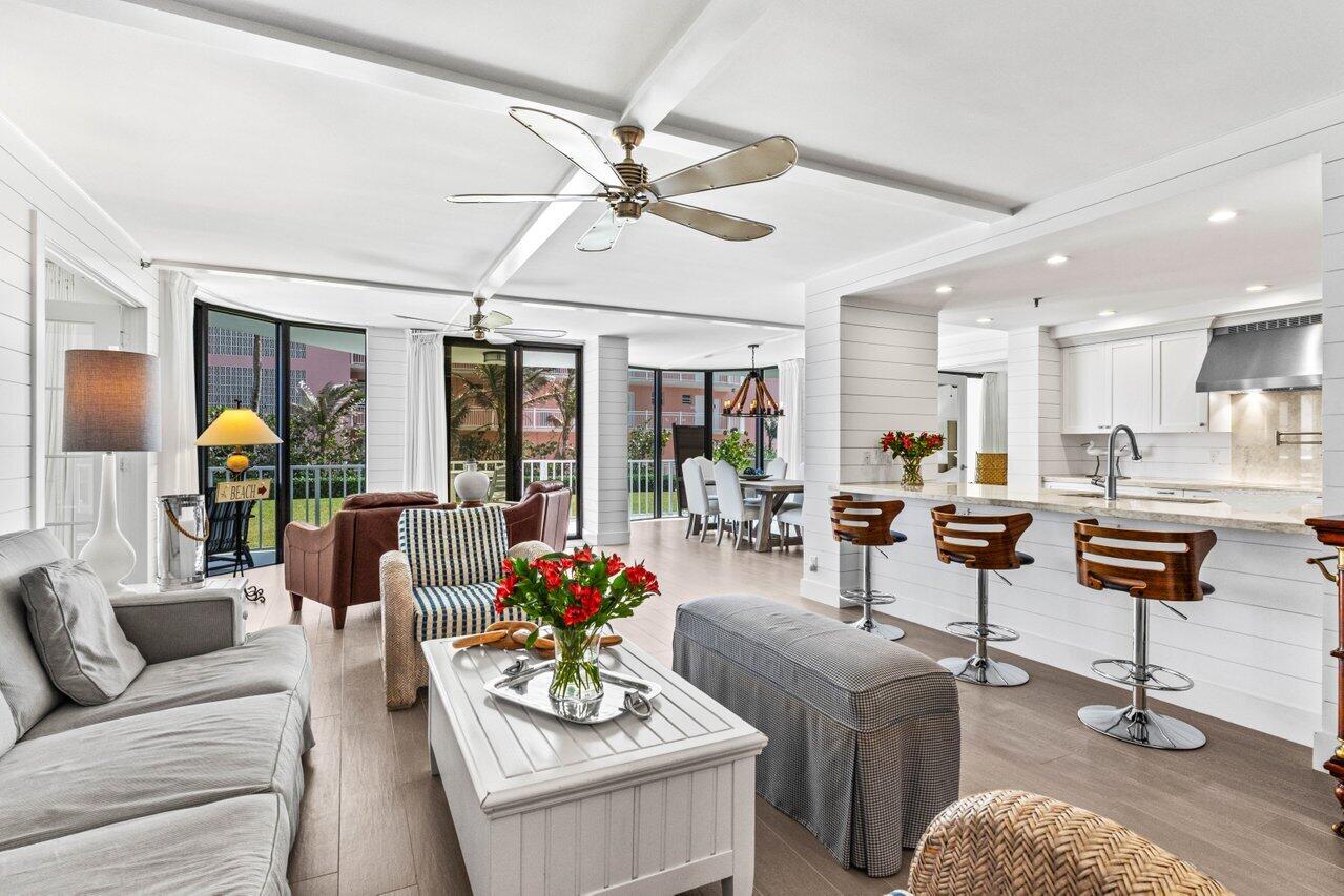 2917 South Ocean Boulevard, Unit 104 Highland Beach, FL 33487 - Photo 29 of 57 a living room with furniture and wooden floor