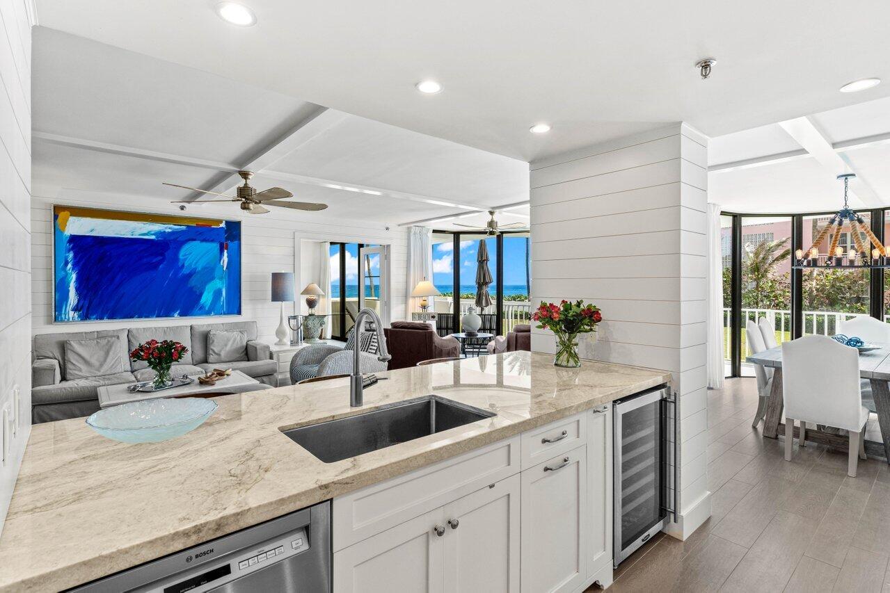 2917 South Ocean Boulevard, Unit 104 Highland Beach, FL 33487 - Photo 7 of 57 a kitchen with stainless steel appliances granite countertop a sink a counter space and a window