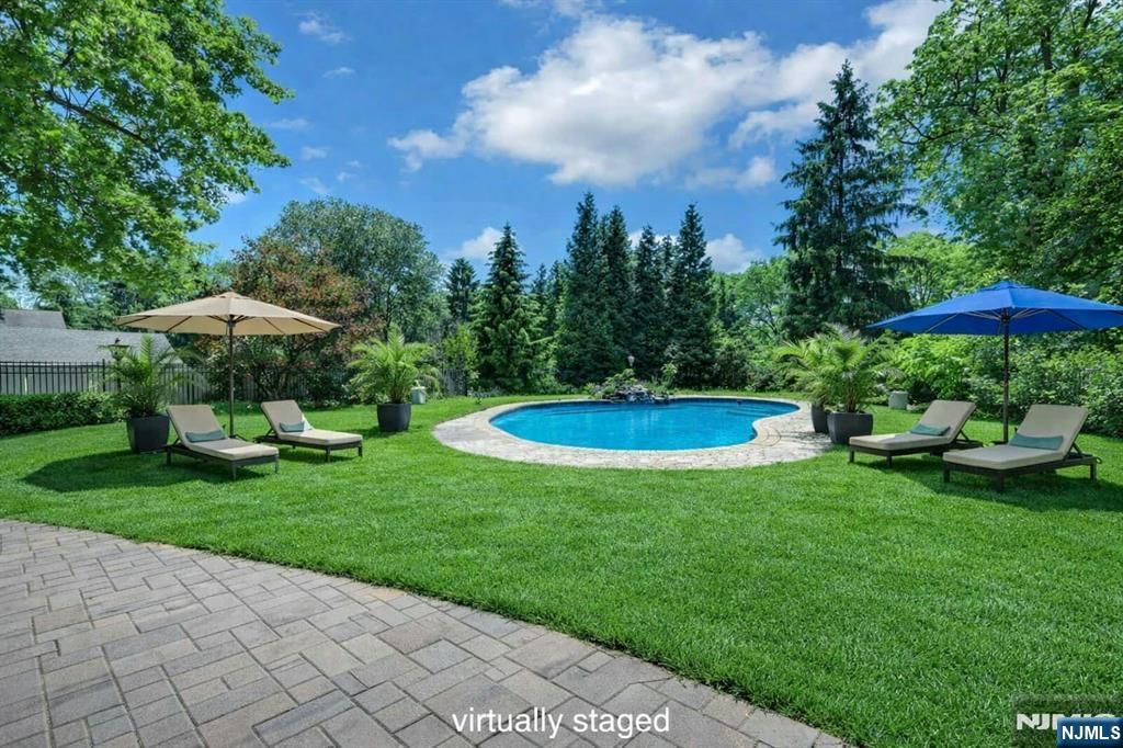 44 West Midland Avenue Paramus, NJ 07652 - Photo 4 of 19 a view of a swimming pool and lounge chairs in back yard