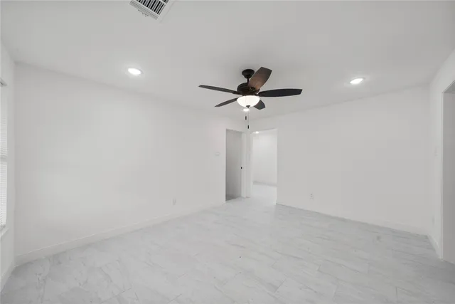 a view of a big room with a ceiling fan