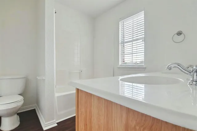 a bathroom with a sink a toilet and a bathtub