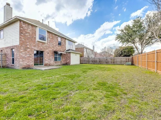 a view of a house with a yard and sitting area