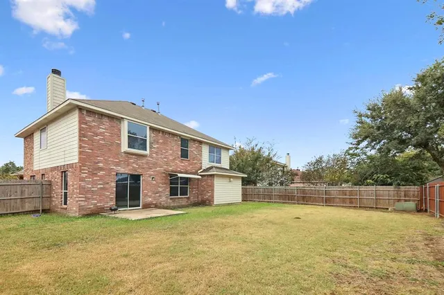 a view of a house with a backyard