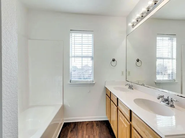 a bathroom with a sink a mirror and a bathtub