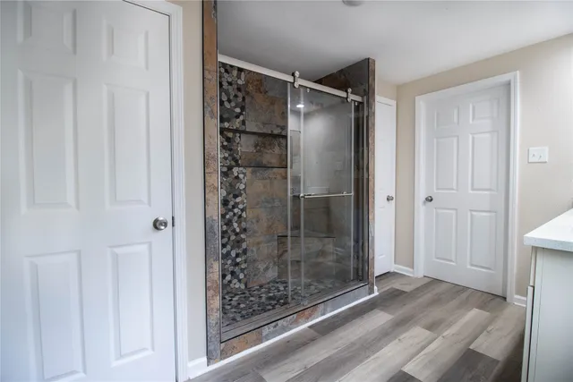 a bathroom with a glass shower door