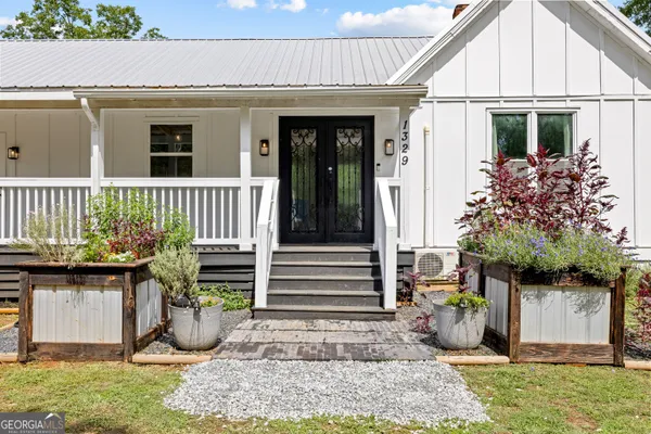 a view of a house with a yard and sitting area