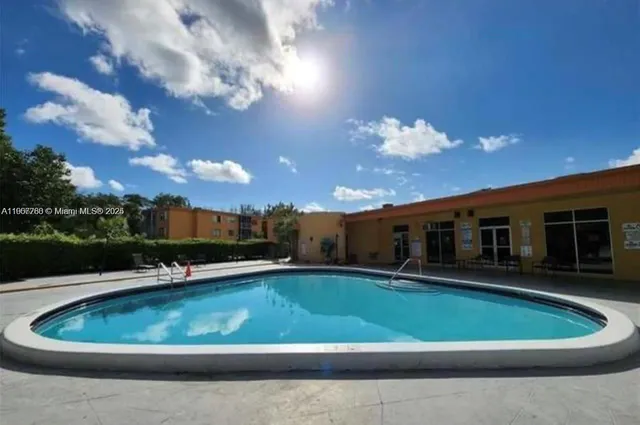 a view of a house with a swimming pool and a yard