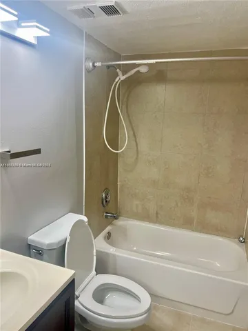 a bathroom with a toilet and a bath tub