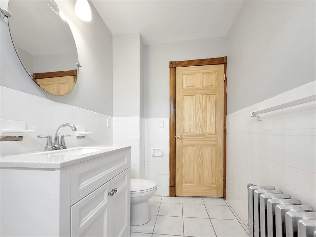 35 Dunlap Street, Unit 2 Boston, MA 02124 - Photo 11 of 12 a bathroom with a sink a toilet and a mirror