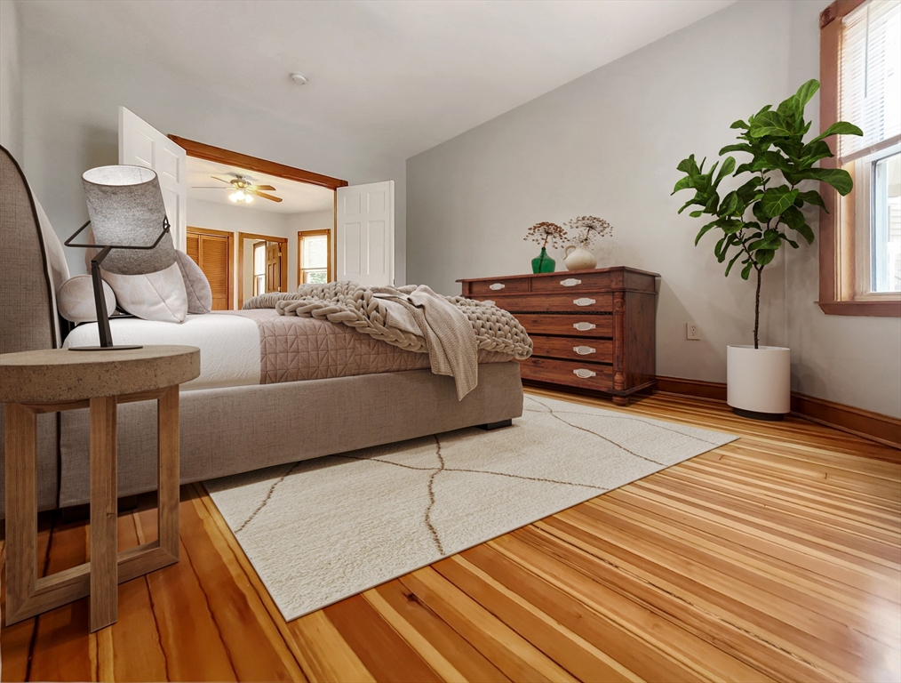 35 Dunlap Street, Unit 2 Boston, MA 02124 - Photo 5 of 12 a bedroom with a bed and a potted plant on the dresser