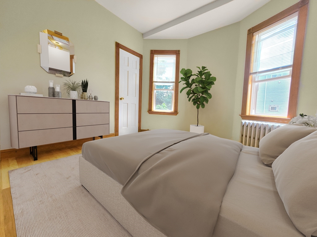 35 Dunlap Street, Unit 2 Boston, MA 02124 - Photo 8 of 12 a bedroom with a bed and window