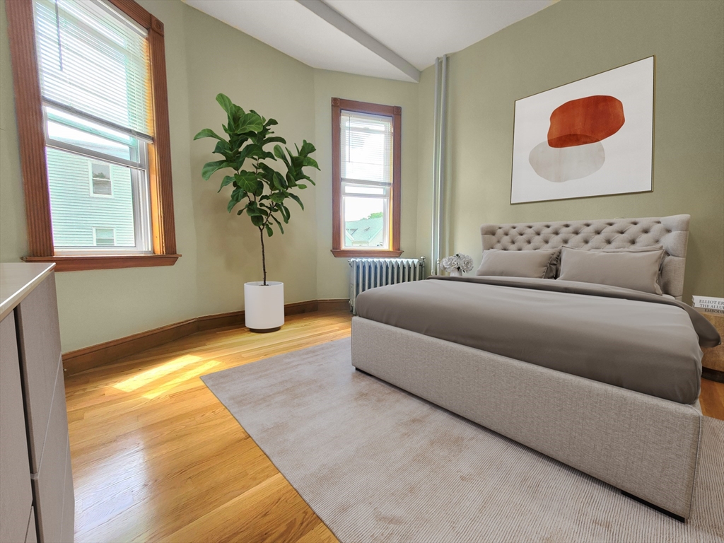 35 Dunlap Street, Unit 2 Boston, MA 02124 - Photo 9 of 12 a bedroom with a bed and a potted plant