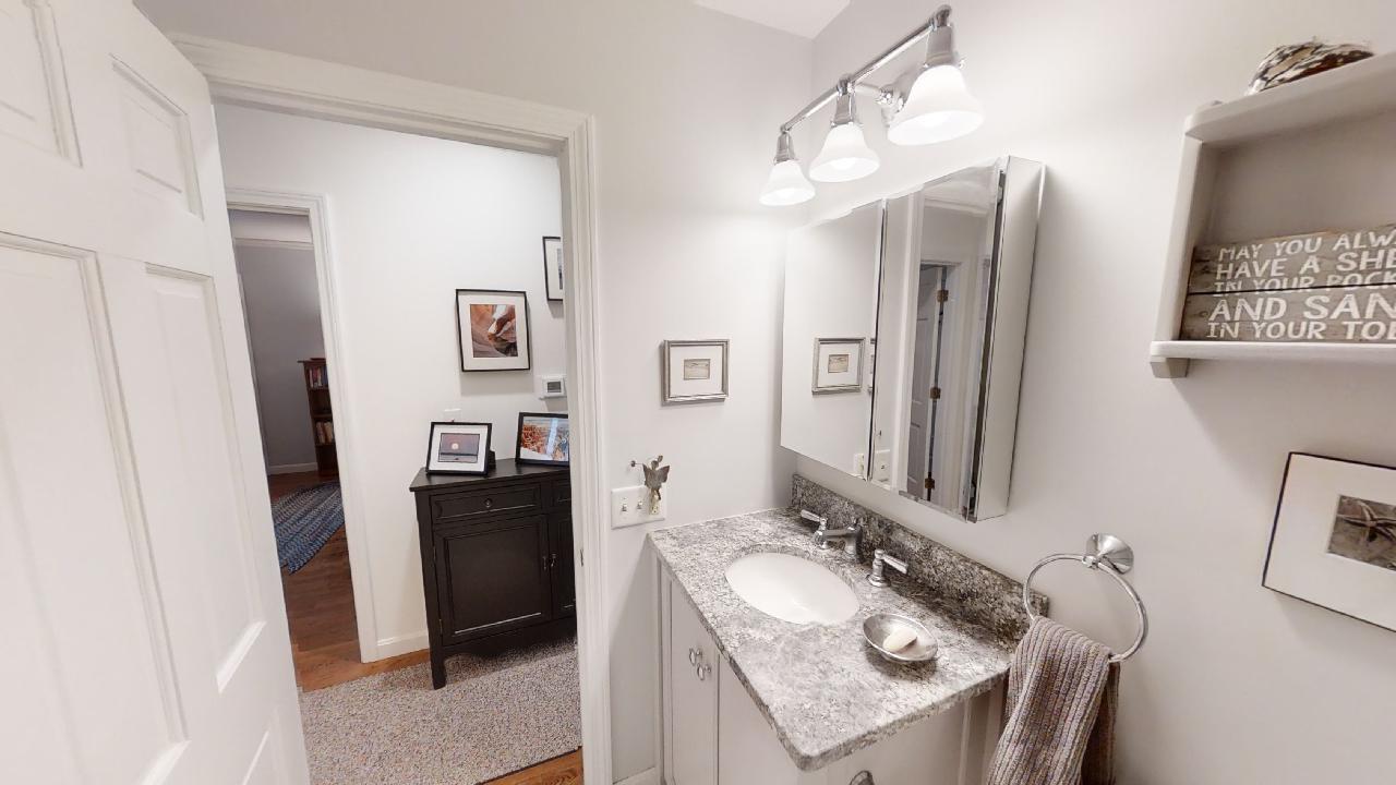 59 Route 6A, Unit 323 Orleans, MA 02653 - Photo 11 of 23 a bathroom with double vanity sink and a mirror