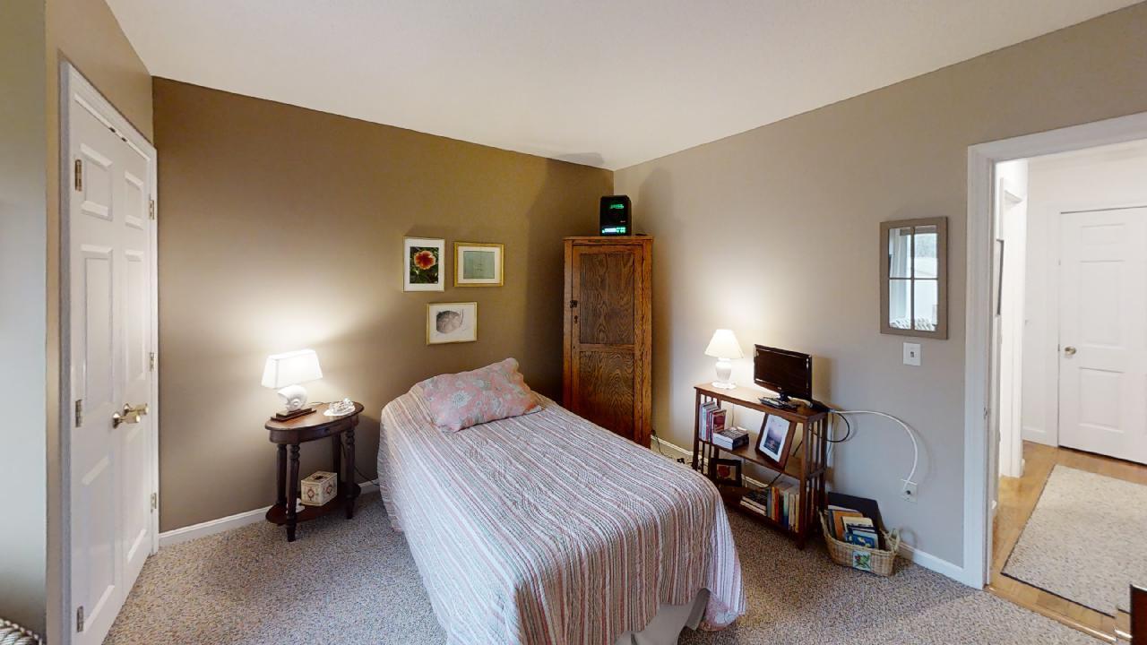 59 Route 6A, Unit 323 Orleans, MA 02653 - Photo 12 of 23 a bedroom with a bed and a desk in it