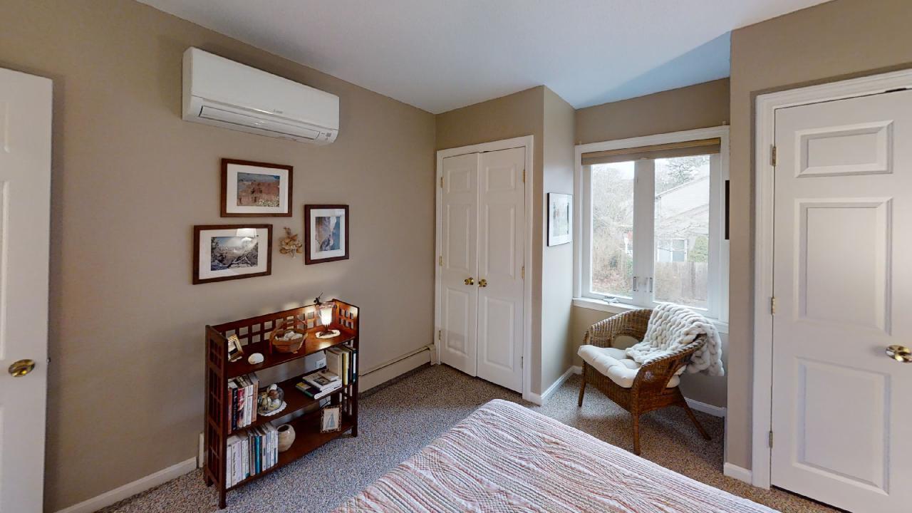 59 Route 6A, Unit 323 Orleans, MA 02653 - Photo 13 of 23 a living room with furniture a rug and a wooden floor