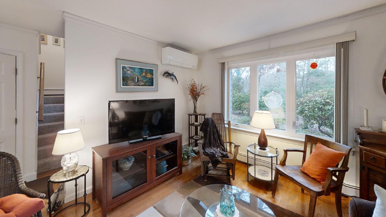 59 Route 6A, Unit 323 Orleans, MA 02653 - Photo 2 of 23 a living room with furniture and a flat screen tv