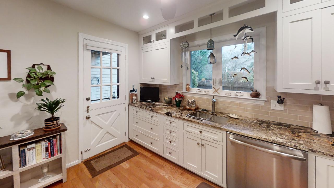 59 Route 6A, Unit 323 Orleans, MA 02653 - Photo 4 of 23 a kitchen with granite countertop a sink stainless steel appliances and cabinets
