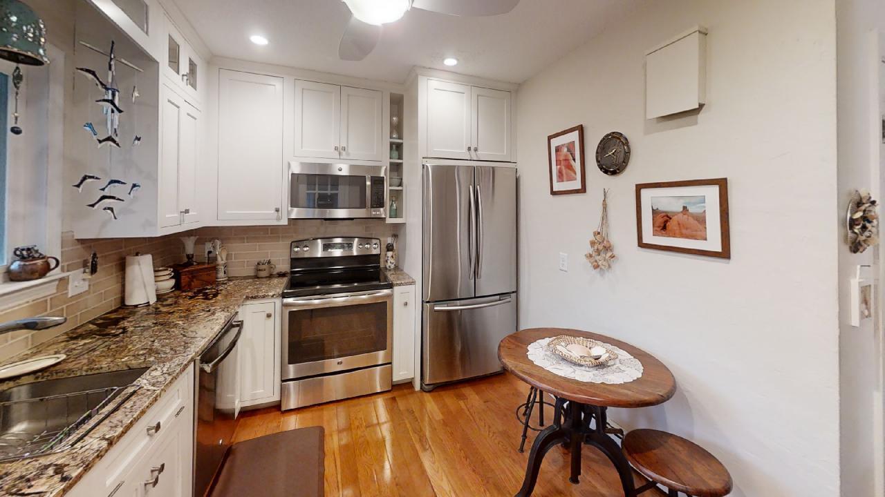 59 Route 6A, Unit 323 Orleans, MA 02653 - Photo 5 of 23 a kitchen with stainless steel appliances granite countertop a stove and a refrigerator