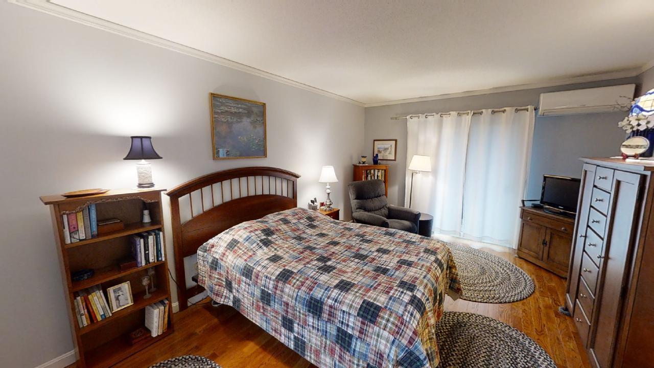 59 Route 6A, Unit 323 Orleans, MA 02653 - Photo 8 of 23 a bedroom with a bed and a dresser in it