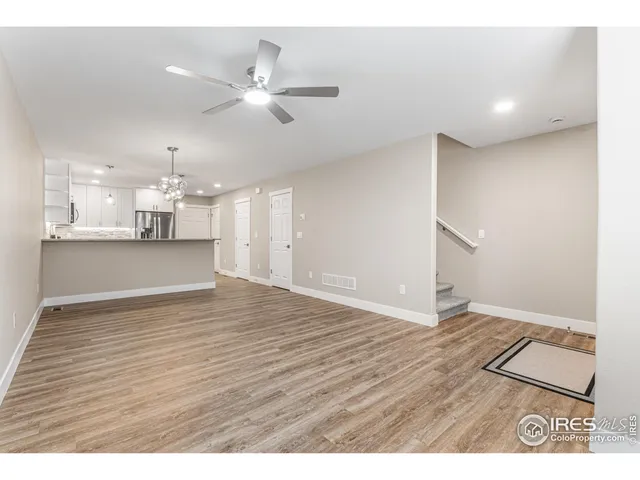 a view of a kitchen with a dishwasher and wooden floor