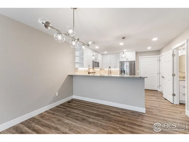 a view of a kitchen with marble kitchen and stainless steel appliances