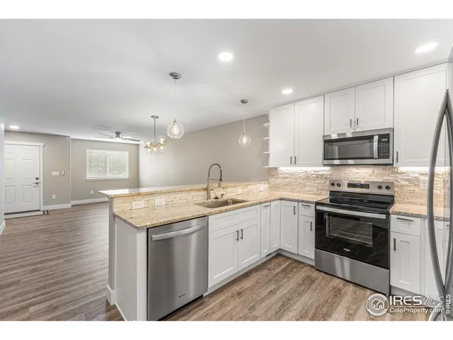 a kitchen with a sink stove and microwave