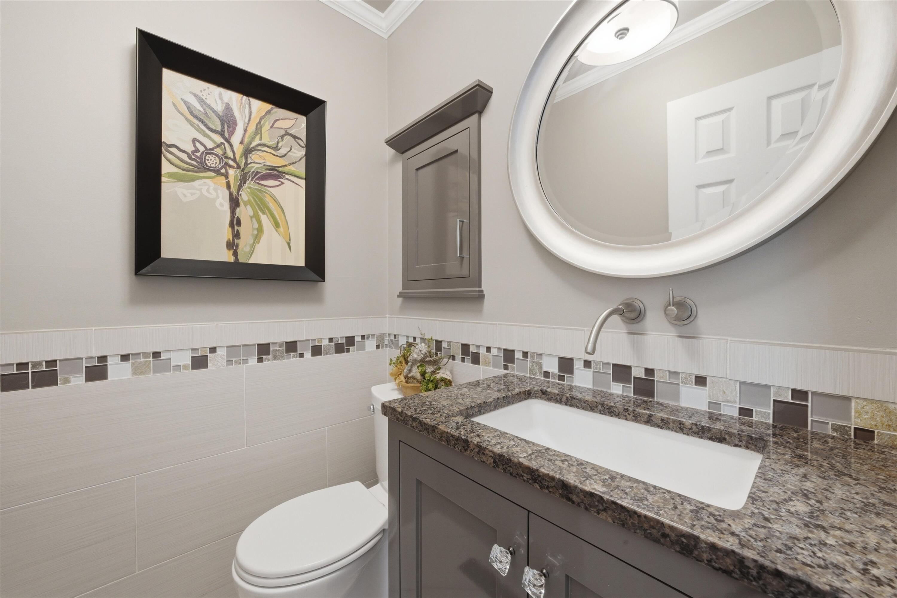 1034 North Indiana Street Griffith, IN 46319 - Photo 9 of 17 a bathroom with a granite countertop toilet sink and mirror