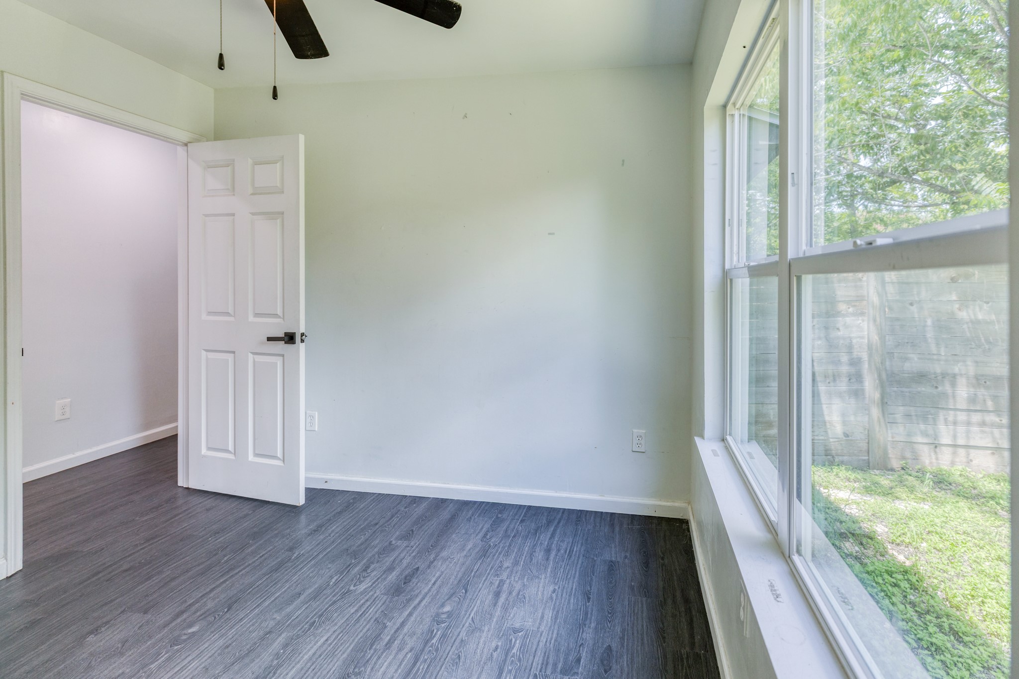 6202 Carnation Terrace Austin, TX 78741 - Photo 15 of 17 an empty room with wooden floor and windows