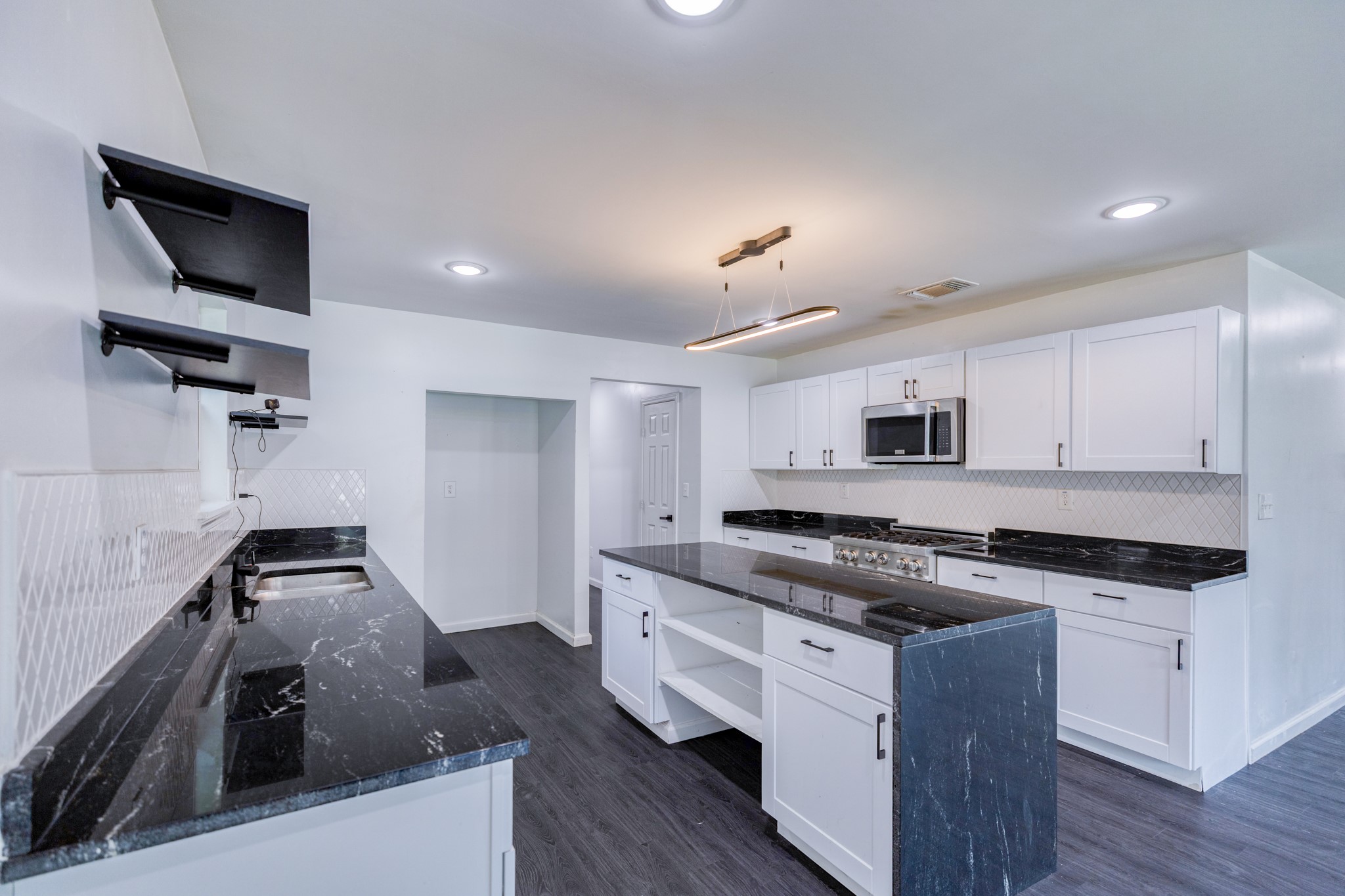 6202 Carnation Terrace Austin, TX 78741 - Photo 4 of 17 a kitchen with stainless steel appliances granite countertop a stove and a sink