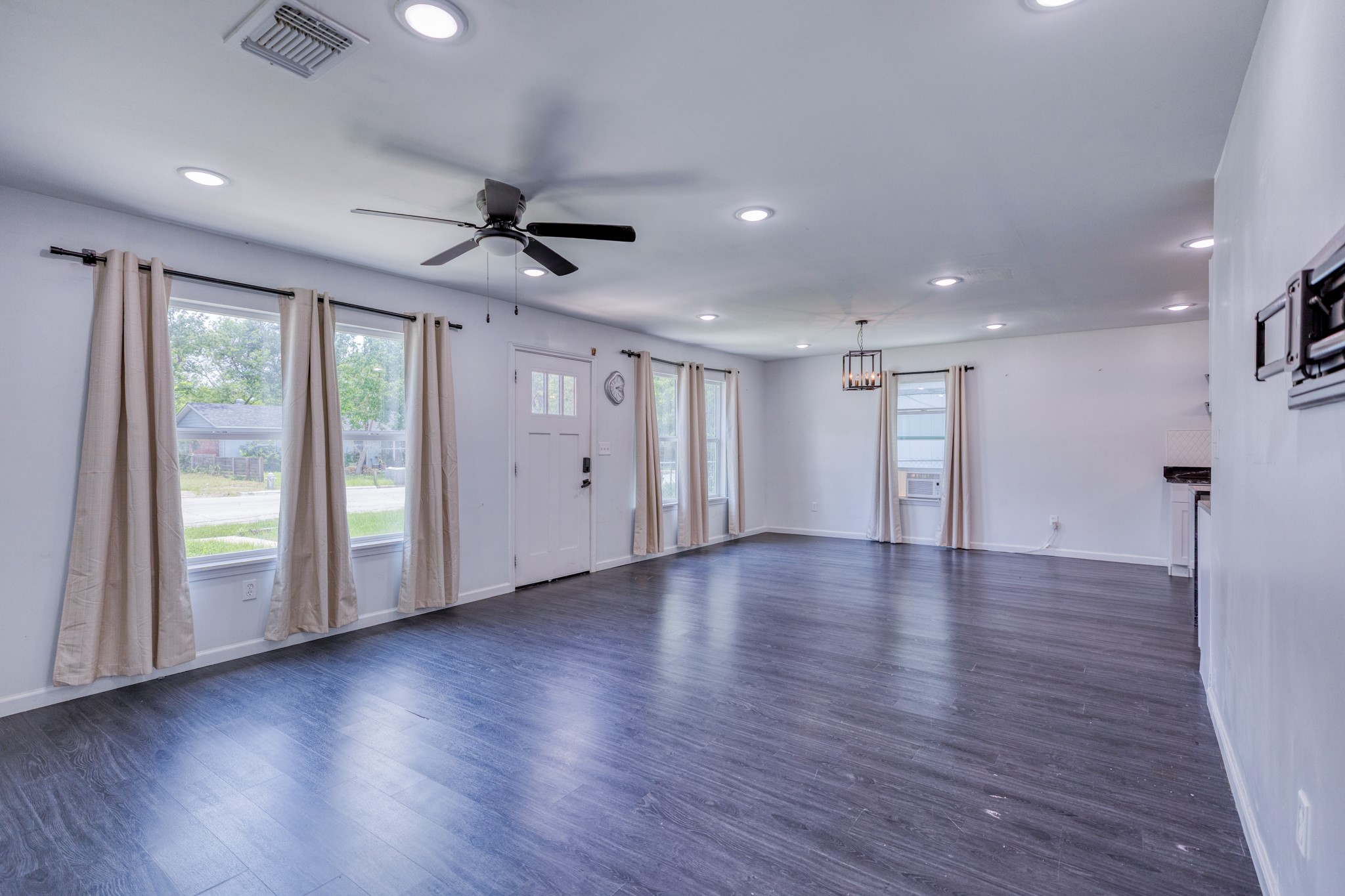 6202 Carnation Terrace Austin, TX 78741 - Photo 5 of 17 a view of an empty room with wooden floor and a window