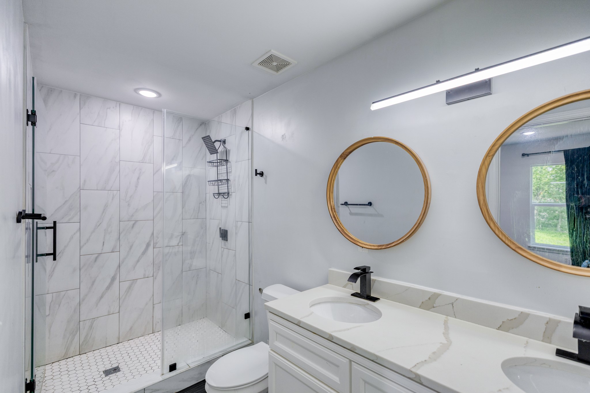 6202 Carnation Terrace Austin, TX 78741 - Photo 10 of 17 a bathroom with a toilet a sink and mirror