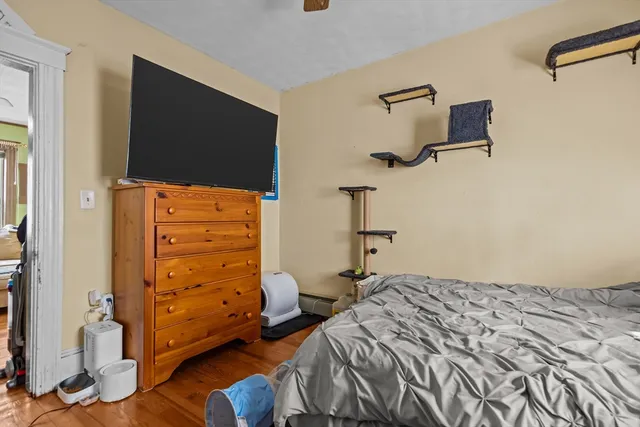 a bedroom with a bed and a flat tv screen