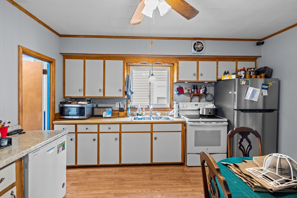 97 Warwick Street Woonsocket, RI 02895 - Photo 12 of 40 a kitchen with sink cabinets and wooden floor