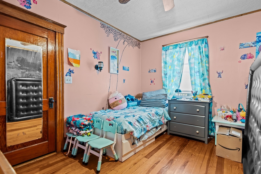 97 Warwick Street Woonsocket, RI 02895 - Photo 14 of 40 a bedroom with a bed and wooden floor