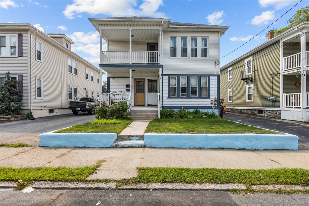 97 Warwick Street Woonsocket, RI 02895 - Photo 2 of 40 a white building with glass windows and yard