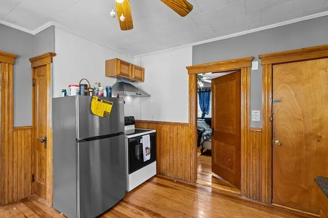 a view of a refrigerator in kitchen and a window