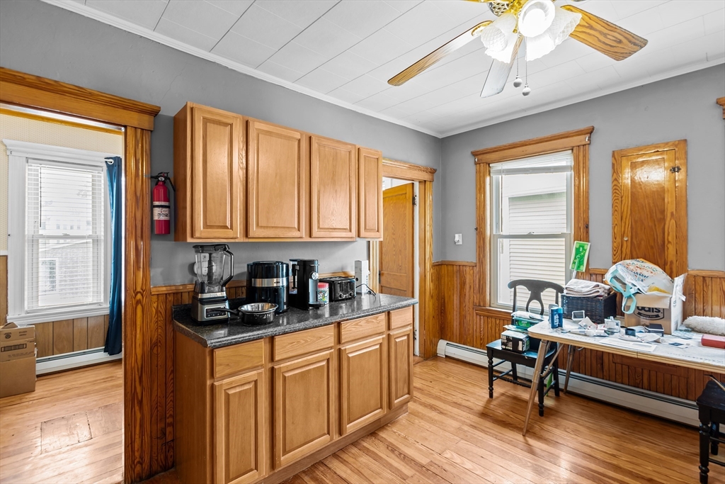 97 Warwick Street Woonsocket, RI 02895 - Photo 28 of 40 a kitchen with sink refrigerator dining table and chairs